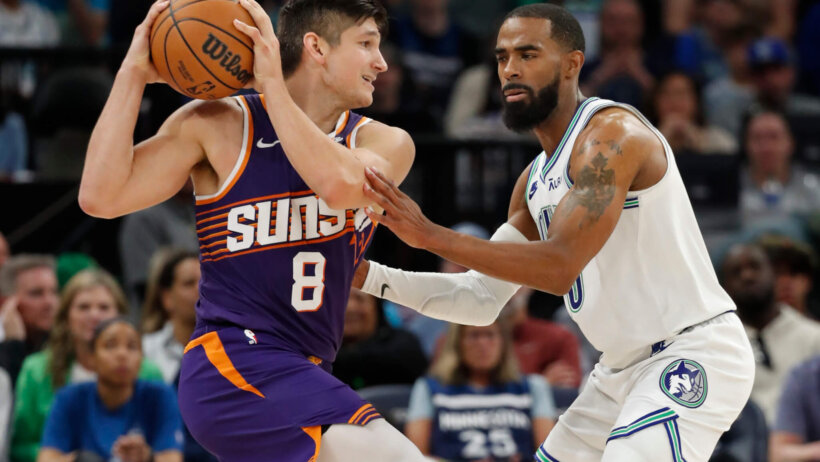 Phoenix Suns guard Grayson Allen holds the ball as Minnesota Timberwolves guard Mike Conley defends