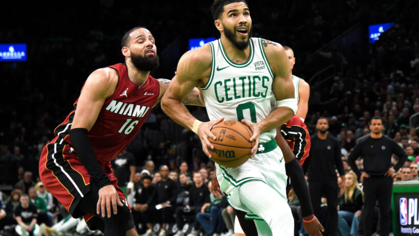 Boston Celtics forward Jayson Tatum (0) drives to the basket past Miami Heat forward Caleb Martin