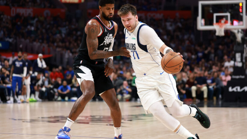 Dallas Mavericks guard Luka Doncic dribbles the ball against Los Angeles Clippers forward Paul George
