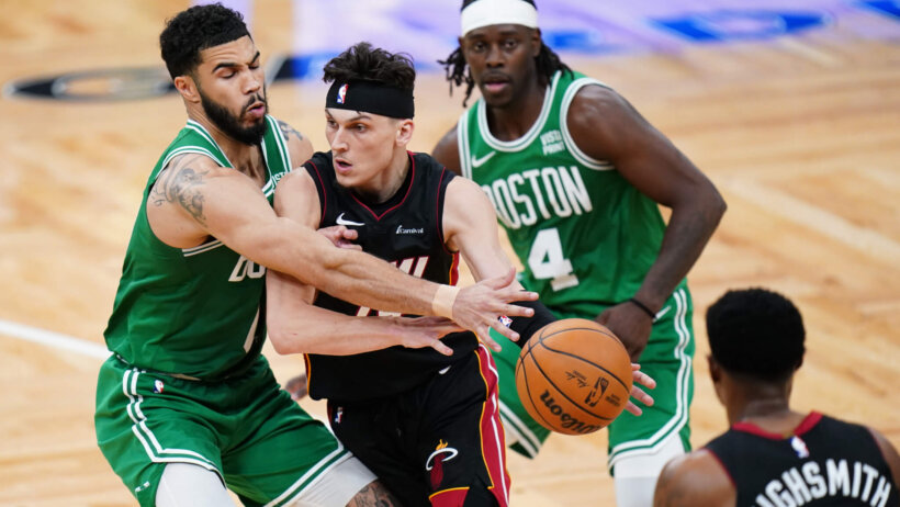 Miami Heat guard Tyler Herro drives the ball against Boston Celtics forward Jayson Tatum in the second half during game two of the first round for the 2024 NBA playoffs