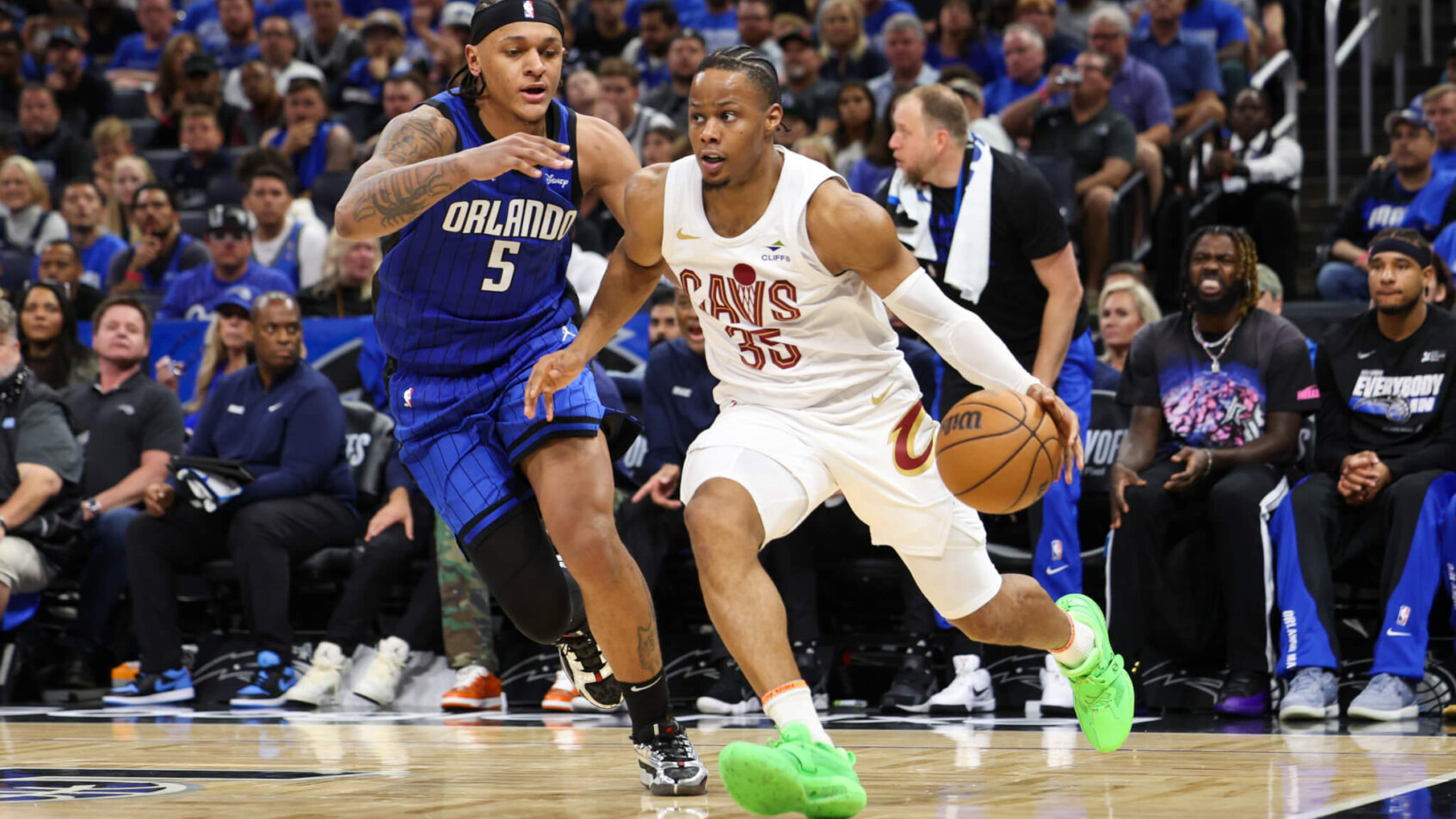 Cleveland Cavaliers forward Isaac Okoro tries to dribble around Orlando Magic forward Paolo Banchero