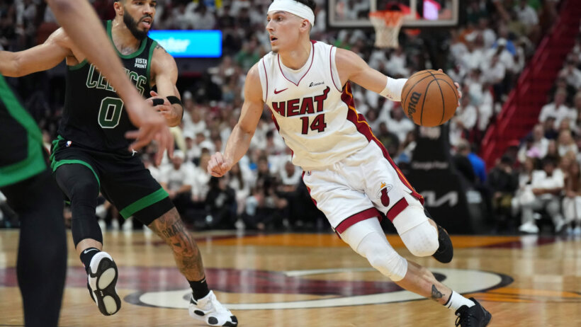 Miami Heat guard Tyler Herro dribbles around Boston Celtics forward Jayson Tatum