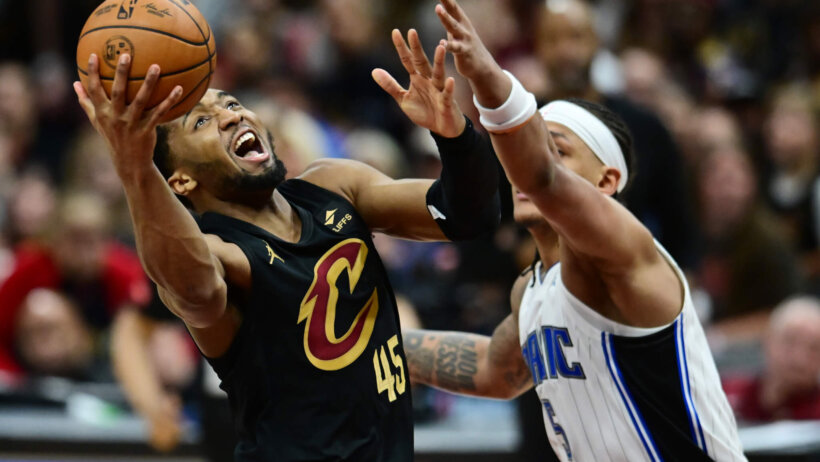 Cleveland Cavaliers guard Donovan Mitchell goes for a layup against Orlando Magic forward Paolo Banchero