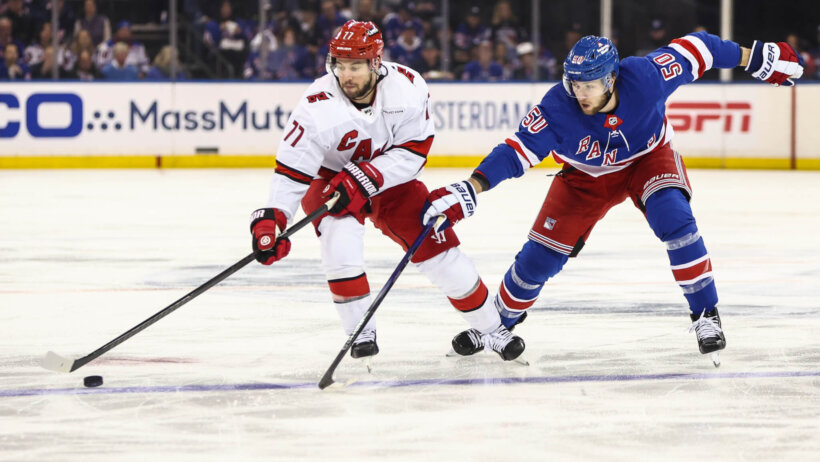 Carolina Hurricanes defenseman Tony DeAngelo and New York Rangers left wing Will Cuylle battle