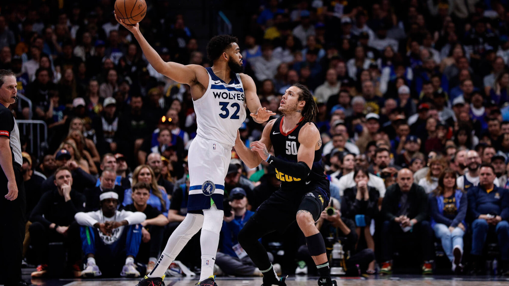Minnesota Timberwolves forward Karl-Anthony Towns holds off Denver Nuggets forward Aaron Gordon