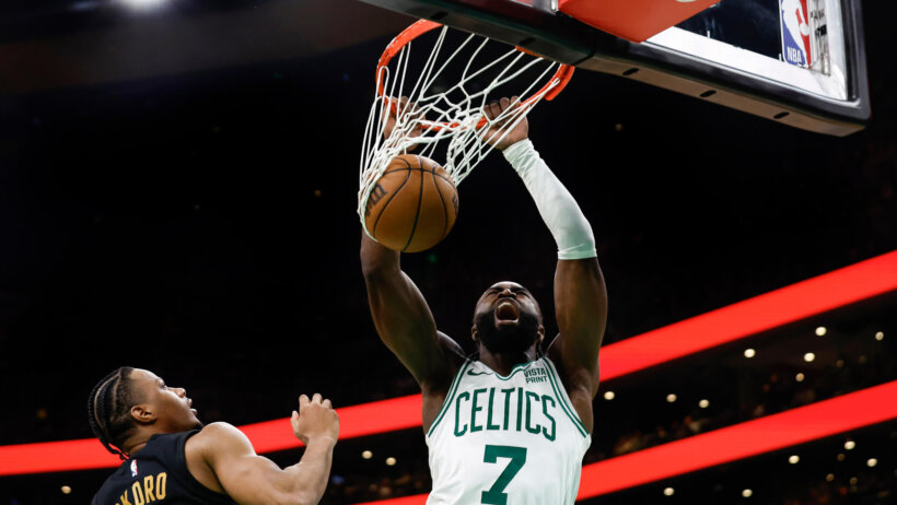 Boston Celtics guard Jaylen Brown dunking against the Cleveland Cavaliers