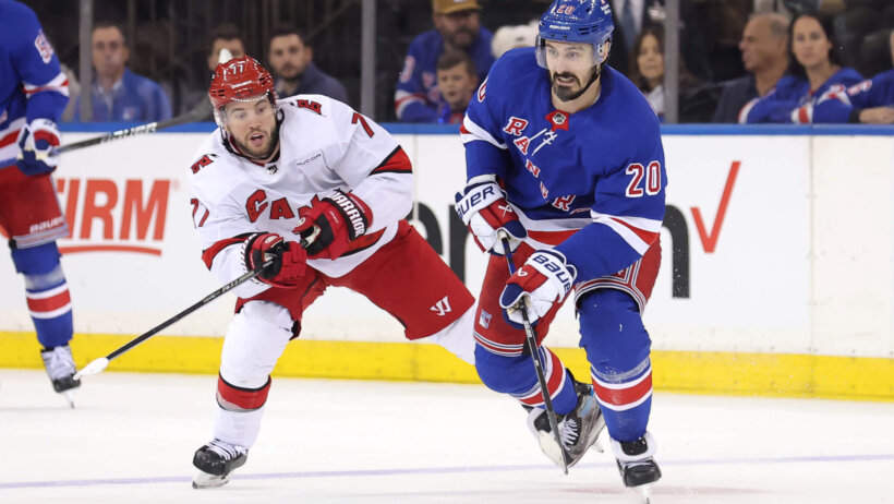 New York Rangers left wing Chris Kreider skates with the puck against Carolina Hurricanes defenseman Tony DeAngelo