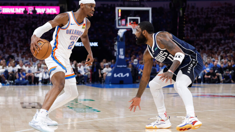 Oklahoma City Thunder guard Shai Gilgeous-Alexander looks to dribble around Dallas Mavericks guard Kyrie Irving