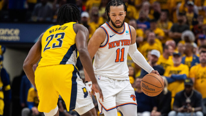New York Knicks guard Jalen Brunson dribbles the ball while Indiana Pacers forward Aaron Nesmith defends