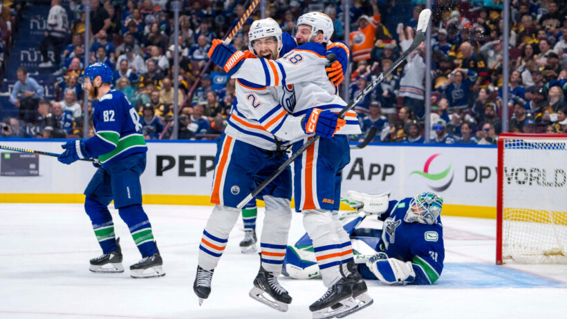 Edmonton Oilers defenseman Evan Bouchard and forward Zach Hyman celebrate an OT goal against the Vancouver Canucks