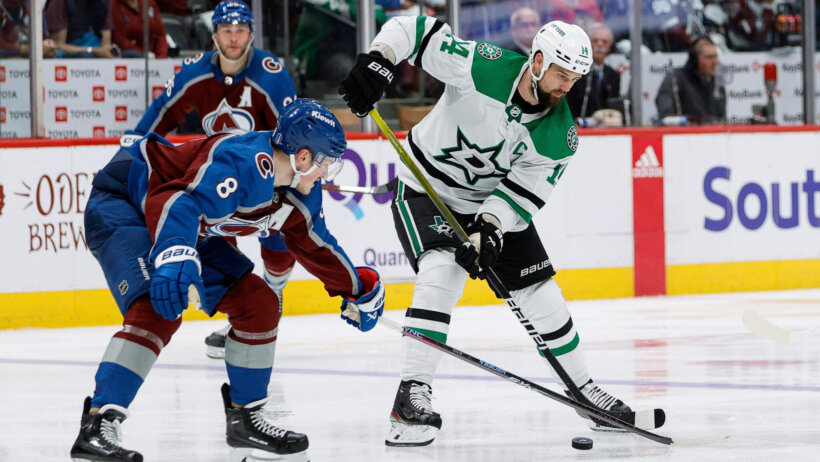 Dallas Stars left wing Jamie Benn passes the puck as Colorado Avalanche defenseman Cale Makar defends