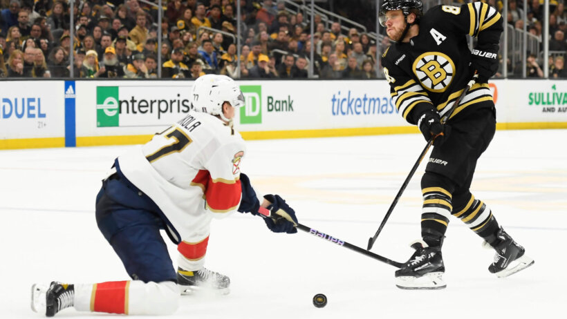 Boston Bruins right wing David Pastrnak passes the puck past Florida Panthers defenseman Niko Mikkola