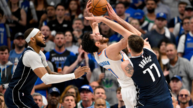 Oklahoma City Thunder forward Chet Holmgren getting fouled by Dallas Mavericks guard Luka Doncic