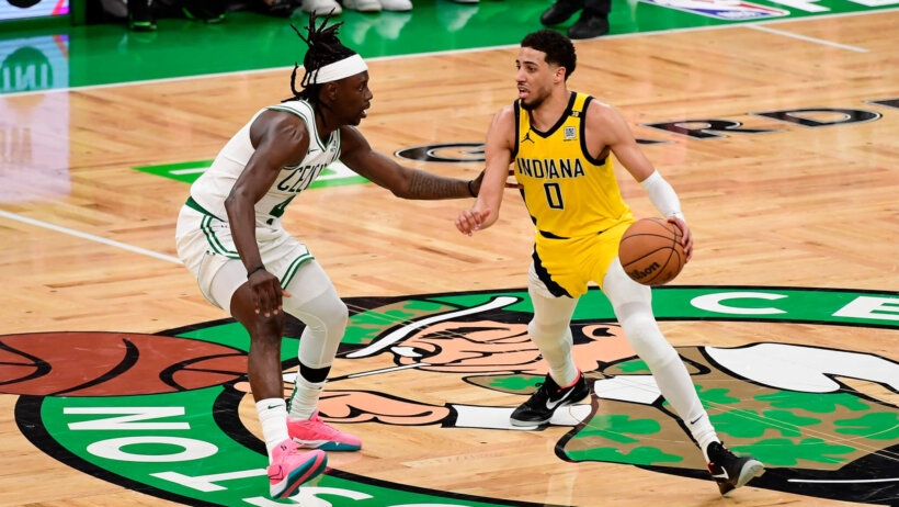 Indiana Pacers guard Tyrese Haliburton dribbling as Boston Celtics guard Jrue Holiday defends