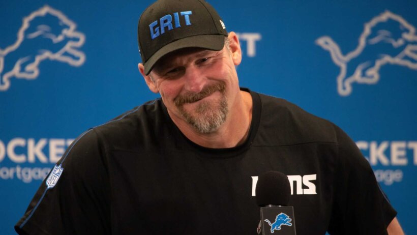 Dan Campbell answering questions at the podium