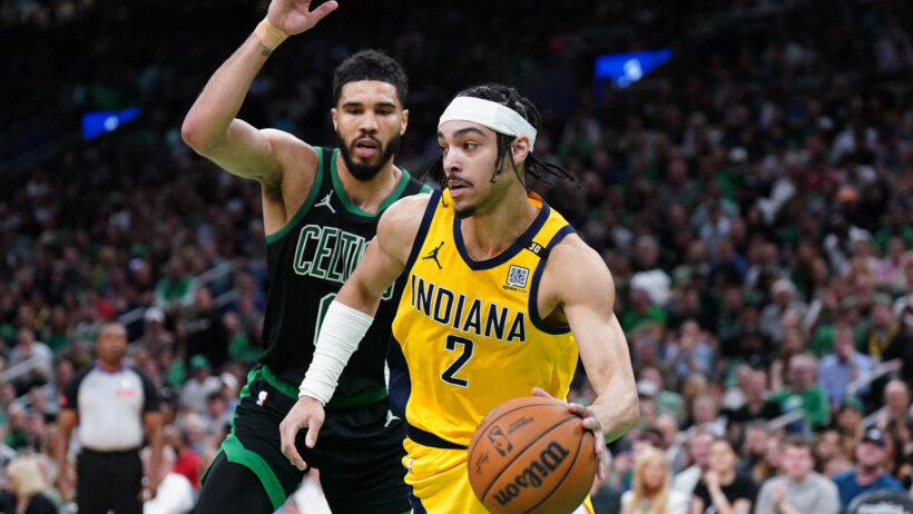 Indiana Pacers guard Andrew Nembhard dribbles the ball around Boston Celtics forward Jayson Tatum