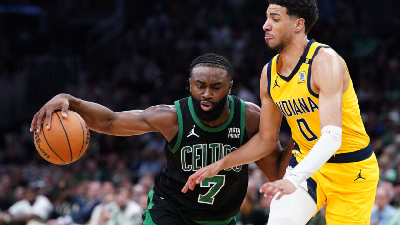 Boston Celtics guard Jaylen Brown dribbles the ball against Indiana Pacers guard Tyrese Haliburton