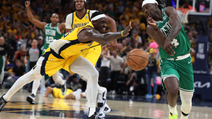 Boston Celtics guard Jrue Holiday races after the ball as Indiana Pacers forward Pascal Siakam attempts to foul