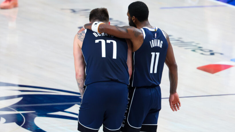 Dallas Mavericks guards Kyrie Irving and Luka Doncic embrace on the court