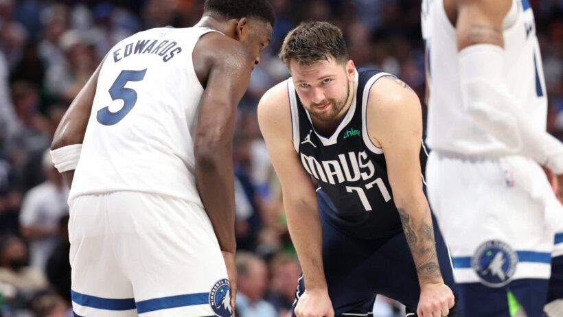 Minnesota Timberwolves guard Anthony Edwards talking to Dallas Mavericks guard Luka Doncic on the court