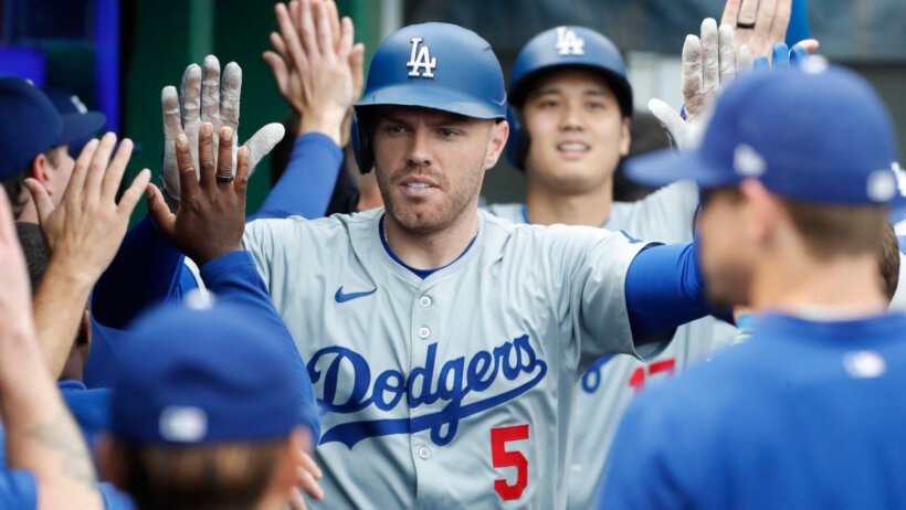 Freddie Freeman celebrates with his Dodger teammates after hitting a home run.