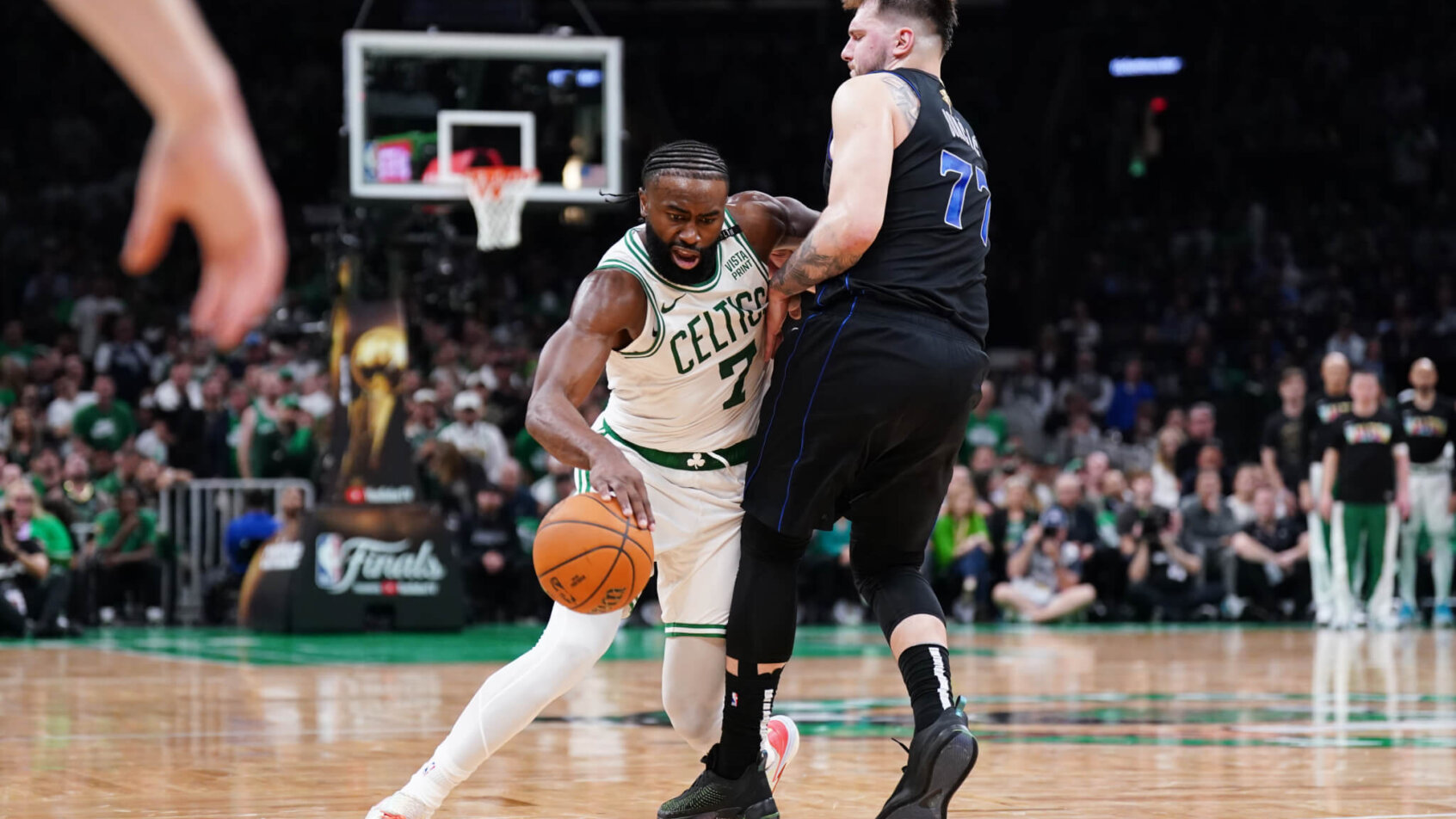 Boston Celtics guard Jaylen Brown tried to dribble around Dallas Mavericks guard Luka Doncic