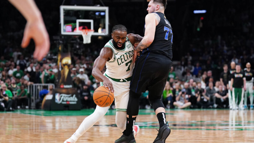 Boston Celtics guard Jaylen Brown tried to dribble around Dallas Mavericks guard Luka Doncic