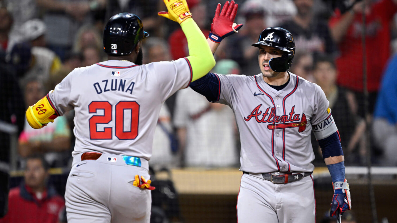 Atlanta Braves designated hitter Marcell Ozuna is congratulated by right fielder Adam Duvall