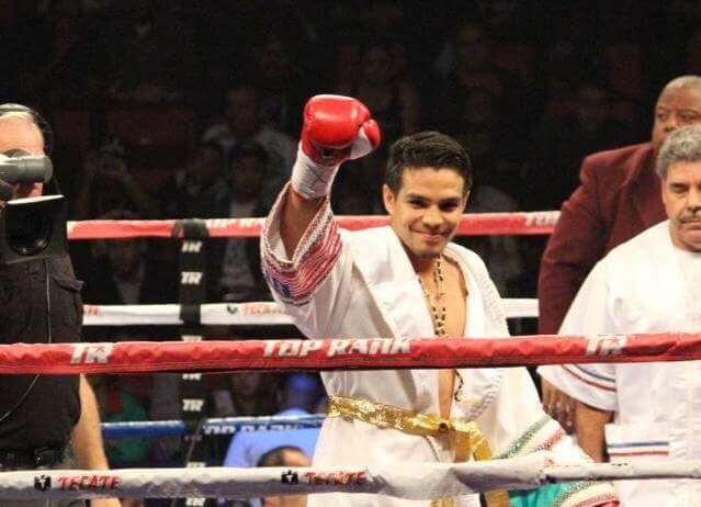 Jose Zepeda with his hand raised
