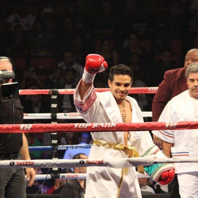 Jose Zepeda with his hand raised