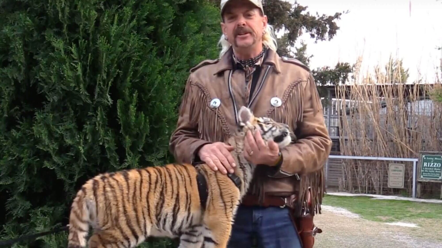 Joe Exotic posing with a tiger