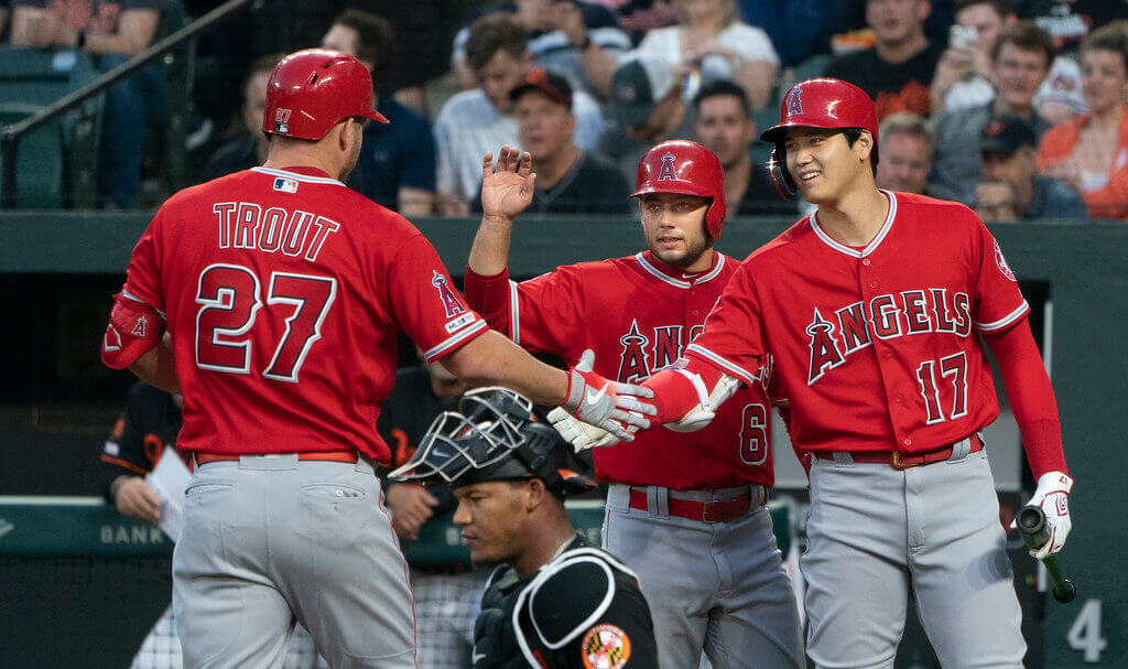 Mike Trout high fiving Shohei Ohtani.