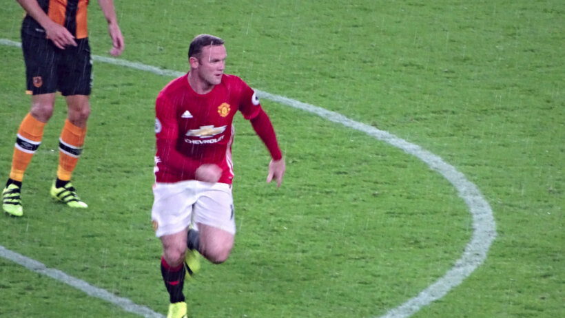 Wayne Rooney runs in rain