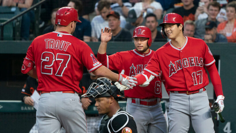 Mike Trout and Shohei Ohtani high-fiving.