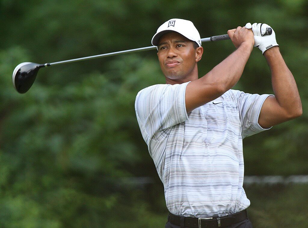 Tiger woods hitting a tee shot